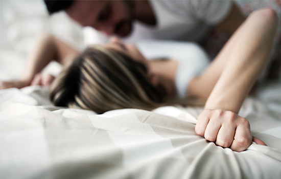 Satisfied couple lies in a bed